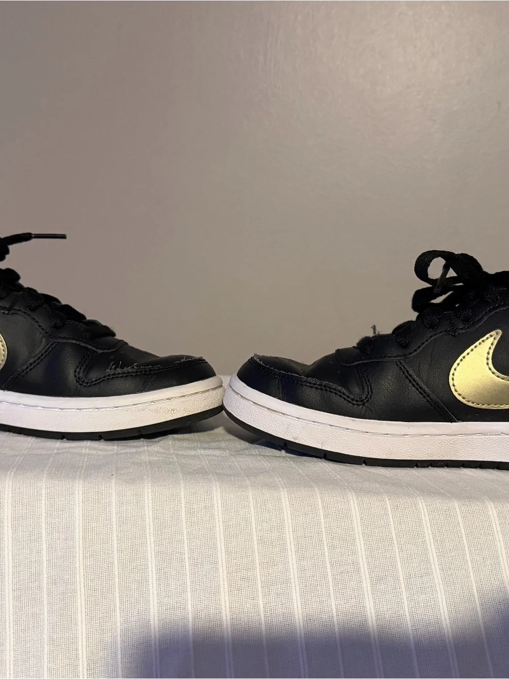 Nike Kids Black Sneakers with Gold Swoosh